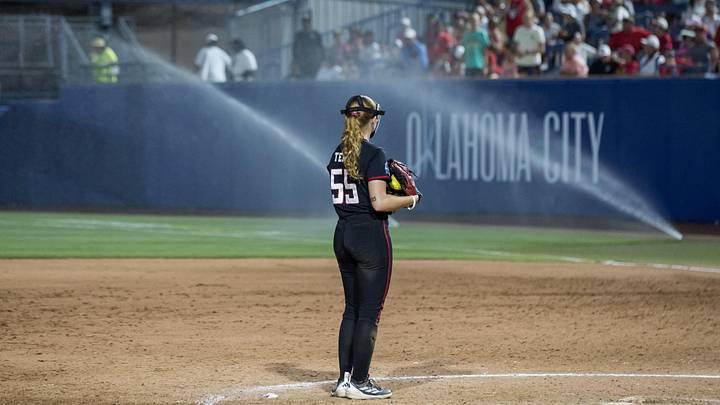 May 31, 2026; Oklahoma City, OK, USA;  Texas Tech Red Raiders pitcher Kaitlyn Terry (55) looks over as sprinklers come on in the eighth inning against the UCLA Bruins during the NCAA Women’s College World Series at Devon Park. Mandatory Credit: Brett Rojo-Imagn Images