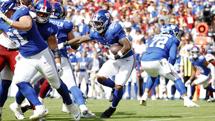 Sep 7, 2025; Landover, Maryland, USA; New York Giants running back Tyrone Tracy Jr. (29) controls the ball during the third quarter against the Washington Commanders at Northwest Stadium. Mandatory Credit: Amber Searls-Imagn Images