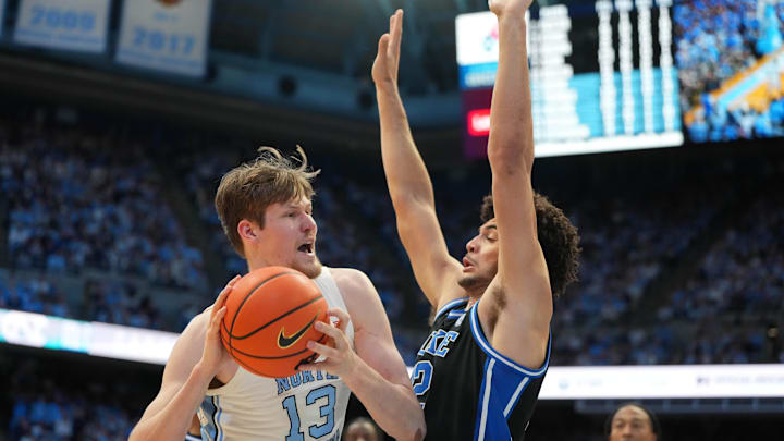 Feb 7, 2026; Chapel Hill, North Carolina, USA; North Carolina Tar Heels center Henri Veesaar (13) with the ball as Duke Blue Devils forward Cameron Boozer (12) defends in the second half.