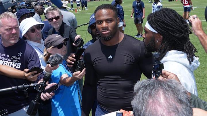 Jul 22, 2025; Oxnard, CA, USA; Dallas Cowboys defensive end Micah Parsons (left) and cornerback Trevon Diggs talks to media during training camp at the River Ridge Fields. Mandatory Credit: Kirby Lee-Imagn Images