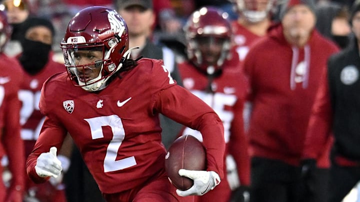 Nov 30, 2024; Pullman, Washington, USA; Washington State Cougars wide receiver Kyle Williams (2) carries the ball against the Wyoming Cowboys in the first half at Gesa Field at Martin Stadium. Mandatory Credit: James Snook-Imagn Images