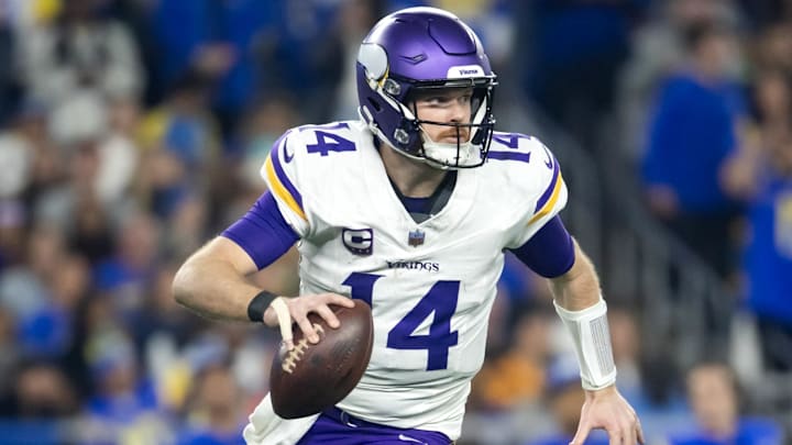 Jan 13, 2025; Glendale, AZ, USA; Minnesota Vikings quarterback Sam Darnold (14) against the Los Angeles Rams during an NFC wild card game at State Farm Stadium. Mandatory Credit: Mark J. Rebilas-Imagn Images