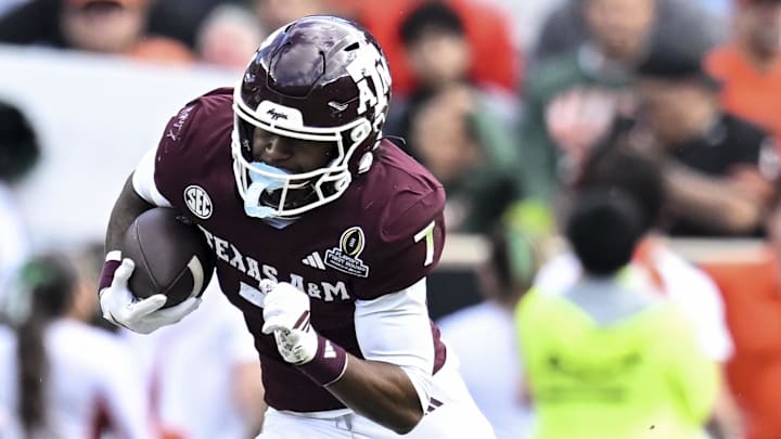 Dec 20, 2025; College Station, TX, USA; Texas A&M Aggies wide receiver KC Concepcion (7) runs the ball against the Miami Hurricanes during the second half at Kyle Field. Mandatory Credit: Maria Lysaker-Imagn Images