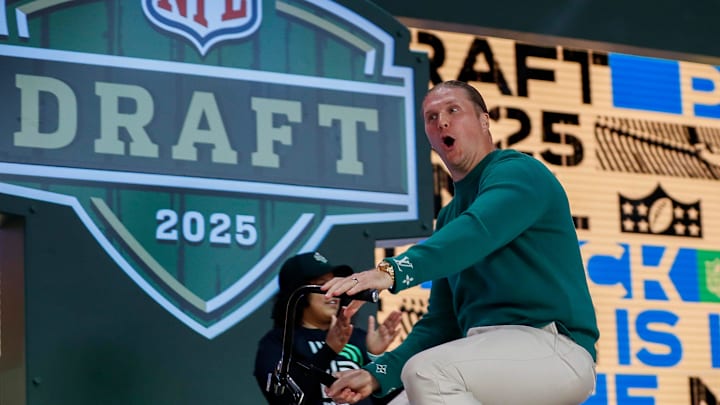Former Green Bay Packers linebacker Clay Matthews rides a bicycle onto the Draft Theater stage before the first round on Thursday.