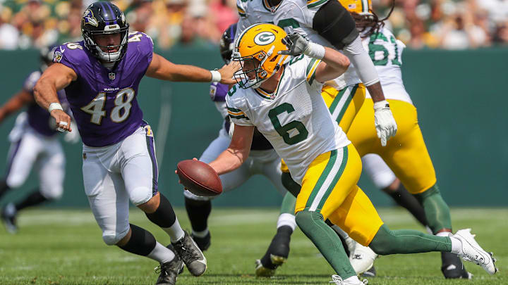 Green Bay Packers quarterback Sean Clifford (6) scrambles away from Baltimore Ravens defensive end Joe Evans (48) during an NFL preseason game on Saturday, August 24, 2024, at Lambeau Field in Green Bay, Wis. 
Tork Mason/USA TODAY NETWORK-Wisconsin