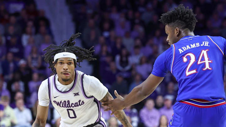 Feb 8, 2025; Manhattan, Kansas, USA; Kansas State Wildcats guard Dug McDaniel (0) dribbles by Kansas Jayhawks forward K.J. Adams (24) during the first half at Bramlage Coliseum. Mandatory Credit: Scott Sewell-Imagn Images