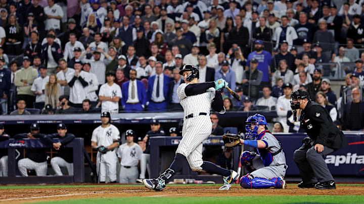 Oct 30, 2024; New York, New York, USA; New York Yankees outfielder Aaron Judge (99) hits a double during the eighth inning against the Los Angeles Dodgers in game four of the 2024 MLB World Series at Yankee Stadium.