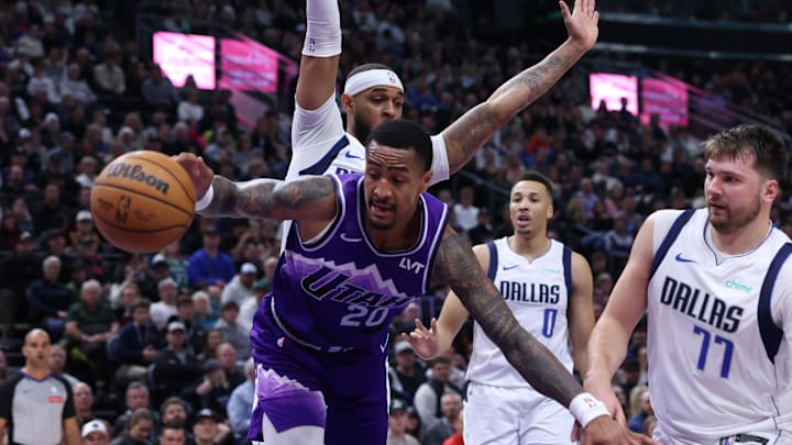 Mar 25, 2024; Salt Lake City, Utah, USA; Utah Jazz forward John Collins (20) reaches for the ball against Dallas Mavericks center Daniel Gafford (rear) and guard Luka Doncic (77) during the third quarter at Delta Center. Mandatory Credit: Rob Gray-Imagn Images