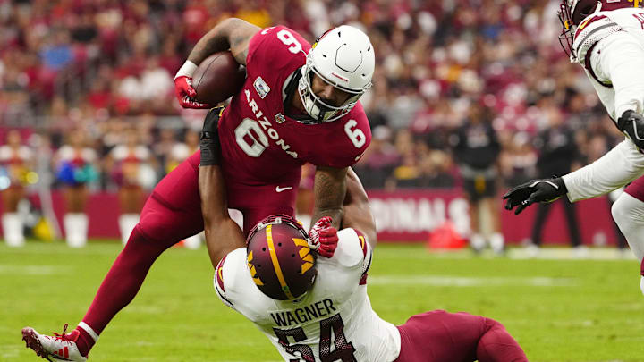 Cardinals running back James Conner (6) stiff arms Commanders linebacker Bobby Wagner (54) during a game at State Farm Stadium in Glendale in Glendale on Sept. 29, 2024.