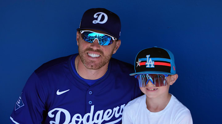 Dodgers first base Freddie Freeman (5) and his son Frederick Charles Freeman II pose for a photo before the game against the Arizona Diamondbacks at Camelback Ranch-Glendale. 