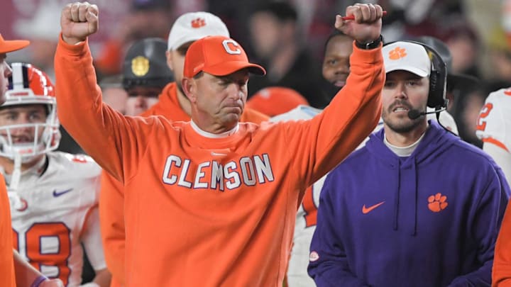 Nov 25, 2023; Columbia, South Carolina, USA; Clemson Tigers head coach Dabo Swinney celebrates with offensive coordinator Garrett Riley as time expires against the South Carolina Gamecocks at Williams-Brice Stadium.  Clemson won 16-7. Mandatory Credit: Ken Ruinard-Imagn Images