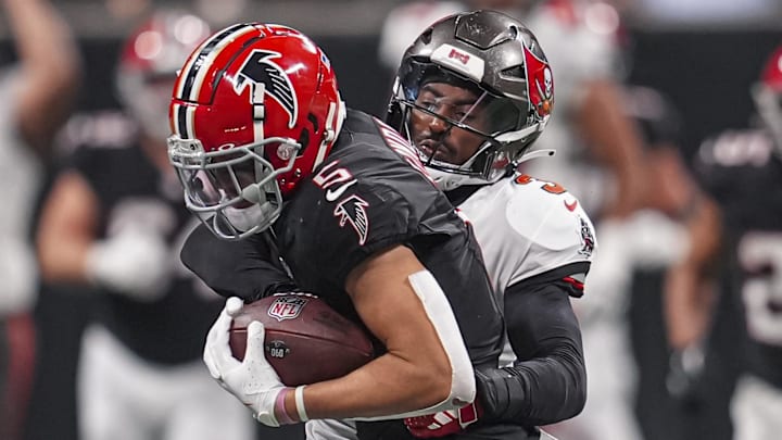 Oct 3, 2024; Atlanta, Georgia, USA; Atlanta Falcons wide receiver Drake London (5) is tackled by Tampa Bay Buccaneers safety Jordan Whitehead (3) after a catch at Mercedes-Benz Stadium. Mandatory Credit: Dale Zanine-Imagn Images
