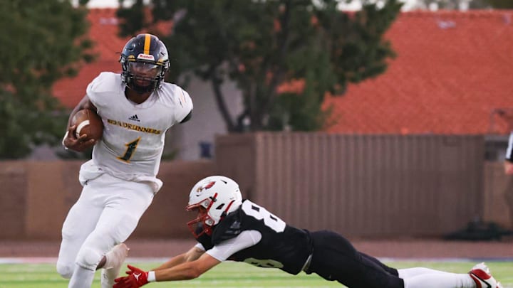 San Tan Charter quarterback Uriah Neloms (1) slips through the defender's hands on Aug. 23, 2024 at Scottsdale Christian HS football stadium in Phoenix.