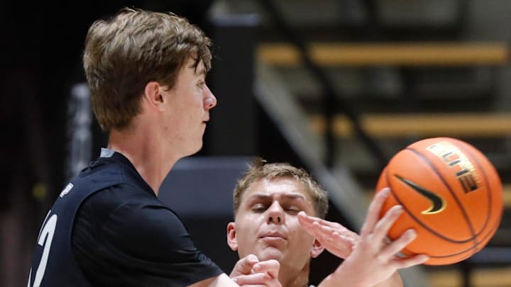 Purdue Boilermakers Daniel Jacobsen (12) is defended by Purdue Boilermakers forward Josh Furst (20) 