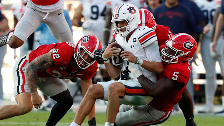 Auburn quarterback Payton Thorne (1) is sacked by Georgia linebacker Raylen Wilson (5) during the second half of a NCAA college football game against Auburn in Athens, Ga., on Saturday, Oct. 5, 2024.