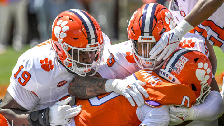 Clemson defensive lineman DeMonte Capehart (19) and Clemson defensive end T.J. Parker (3) tackle Clemson wide receiver Antonio Williams(0) during the Spring football game in Clemson, S.C. Saturday, April 6, 2024. Clemson defensive lineman DeMonte Capehart (19) and Clemson defensive end T.J. Parker (3) tackle Clemson wide receiver Antonio Williams(0) during the Spring football game in Clemson, S.C. Saturday, April 6, 2024.