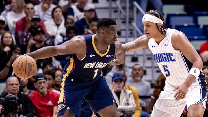Apr 3, 2024; New Orleans, Louisiana, USA;  New Orleans Pelicans forward Zion Williamson (1) dribbles against Orlando Magic forward Paolo Banchero (5) during the first half at Smoothie King Center. Mandatory Credit: Stephen Lew-Imagn Images