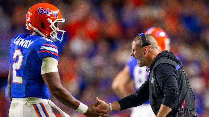 Florida Gators quarterback DJ Lagway (2) is congratulated by Florida Gators head coach Billy Napier after a series during the first half at Ben Hill Griffin Stadium in Gainesville, FL on Saturday, October 19, 2024 against the Kentucky Wildcats. [Doug Engle/Gainesville Sun]
