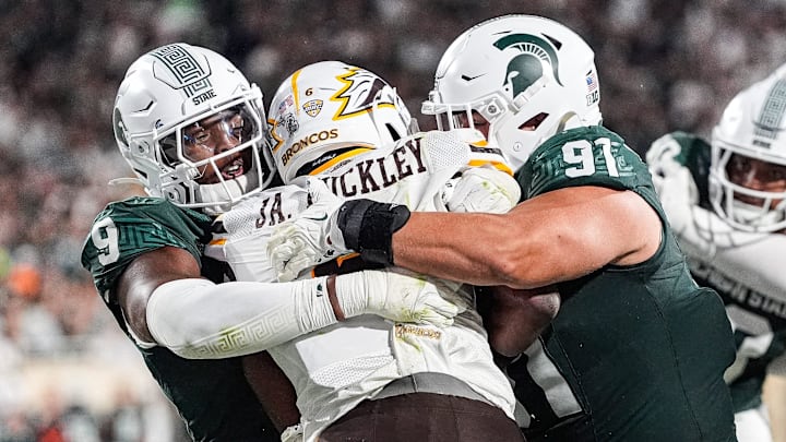 Michigan State defensive lineman Jalen Thompson (9), left, and defensive lineman Alex VanSumeren (91) tackle Western Michigan running back Jalen Buckley (6) for a safety during the second half at Spartan Stadium in East Lansing on Friday, August 29, 2025.