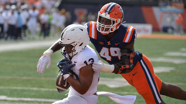 Sep 16, 2023; Champaign, Illinois, USA;  Penn State Nittany Lions running back Kaytron Allen (13) cannot make a catch near the end zone against Illinois Fighting Illini linebacker Seth Coleman (49) during the first half at Memorial Stadium. Mandatory Credit: Ron Johnson-Imagn Images