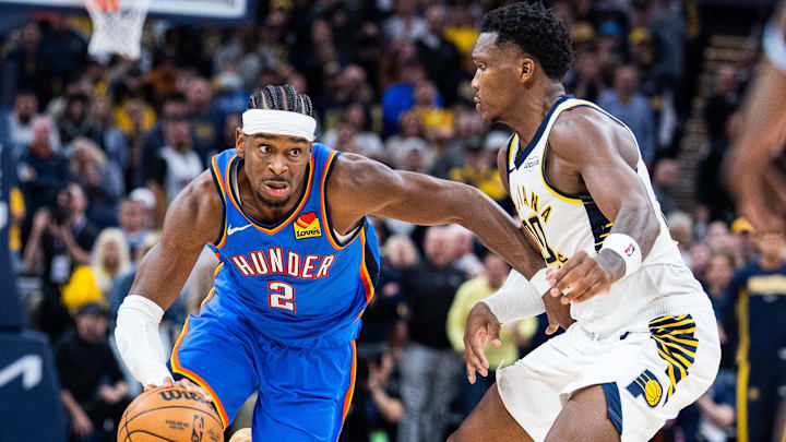 Oct 23, 2025; Indianapolis, Indiana, USA;  Oklahoma City Thunder guard Shai Gilgeous-Alexander (2) dribbles the ball while Indiana Pacers guard Bennedict Mathurin (00) defends in the second half at Gainbridge Fieldhouse. Mandatory Credit: Trevor Ruszkowski-Imagn Images