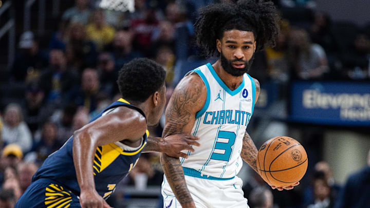 Feb 26, 2026; Indianapolis, Indiana, USA;  Charlotte Hornets guard Coby White (3) dribbles the ball while Indiana Pacers guard Kam Jones (7) defends in the first half at Gainbridge Fieldhouse. Mandatory Credit: Trevor Ruszkowski-Imagn Images