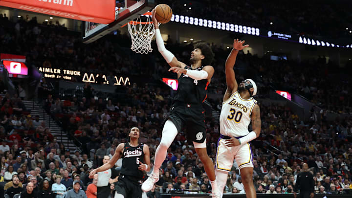 Apr 13, 2025; Portland, Oregon, USA; Portland Trail Blazers guard Matisse Thybulle (4) shoots the ball over Los Angeles Lakers guard Jordan Goodwin (30) as Trail Blazers’ guard Dalano Banton (5) watches in the first half at Moda Center. Mandatory Credit: Jaime Valdez-Imagn Images