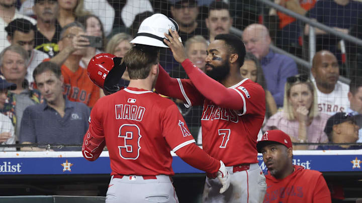 Apr 12, 2025; Houston, Texas, USA; Los Angeles Angels center fielder Jo Adell (7) places a fire helmet on left fielder Taylor Ward (3) after Ward hits a home run during the fifth inning against the Houston Astros at Daikin Park. Mandatory Credit: Troy Taormina-Imagn Images Apr 12, 2025; Houston, Texas, USA; Los Angeles Angels center fielder Jo Adell (7) places a fire helmet on left fielder Taylor Ward (3) after Ward hits a home run during the fifth inning against the Houston Astros at Daikin Park. Mandatory Credit: Troy Taormina-Imagn Images