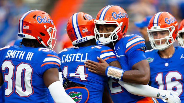 Florida Gators quarterback DJ Lagway (2) gives teammate Florida Gators defensive back Jordan Castell (14) a hug during warm ups before the start of the game at Ben Hill Griffin Stadium in Gainesville, FL on Saturday, September 7, 2024 against the Samford Bulldogs. [Doug Engle/Gainesville Sun]