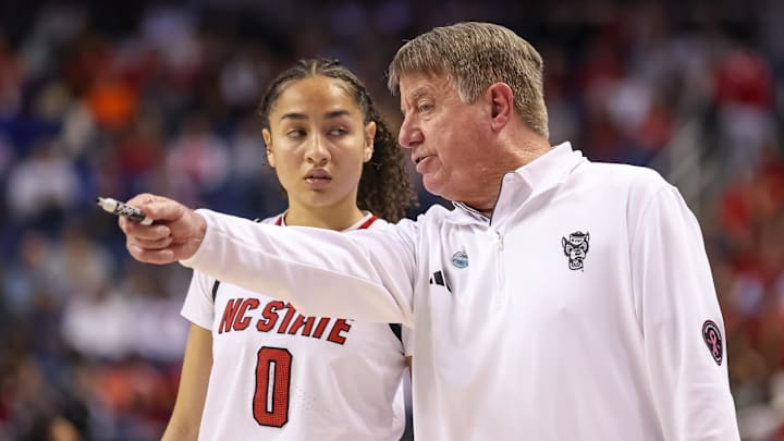 Mar 9, 2025; Greensboro, NC, USA;  NC State Wolfpack head coach Wes Moore talks with NC State Wolfpack guard Devyn Quigley (0) during the fourth quarter against Duke Blue Devils at First Horizon Coliseum. Mandatory Credit: Cory Knowlton-Imagn Images