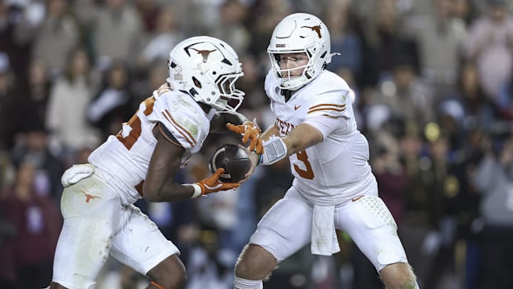 Nov 30, 2024; College Station, Texas, USA; Texas Longhorns quarterback Quinn Ewers (3) hands off to running back Quintrevion Wisner (26) during the fourth quarter at Kyle Field. Mandatory Credit: Troy Taormina-Imagn Images