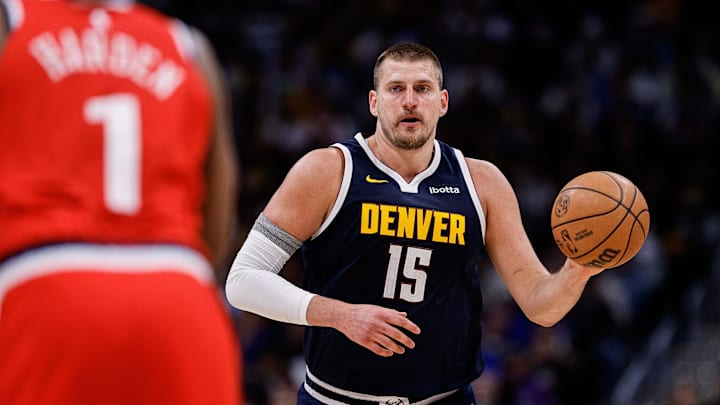 Apr 21, 2025; Denver, Colorado, USA; Denver Nuggets center Nikola Jokic (15) dribbles the ball up court against Los Angeles Clippers guard James Harden (1) in the third quarter during game two of first round for the 2025 NBA Playoffs at Ball Arena. Mandatory Credit: Isaiah J. Downing-Imagn Images