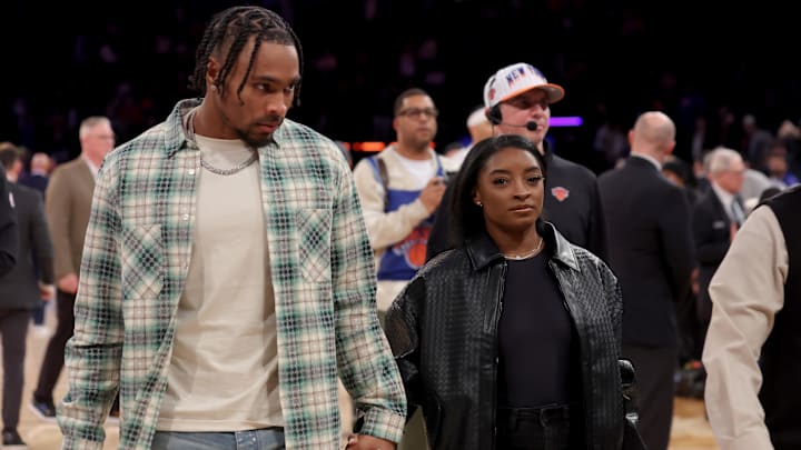 Jan 10, 2025; New York, New York, USA; American gymnast Simone Biles (right) and her husband NFL player Jonathan Owens walk off the court following a game between the New York Knicks and the Oklahoma City Thunder at Madison Square Garden. 