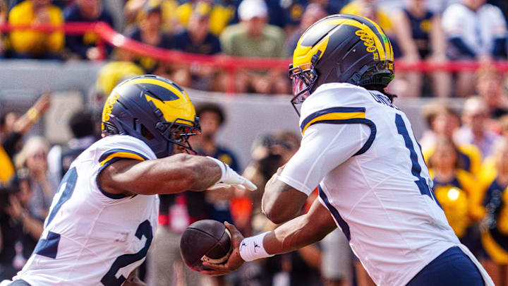 Sep 20, 2025; Lincoln, Nebraska, USA; Michigan Wolverines quarterback Bryce Underwood (19) hands the ball off to running back Justice Haynes (22) against the Nebraska Cornhuskers during the first quarter at Memorial Stadium. Mandatory Credit: Dylan Widger-Imagn Images