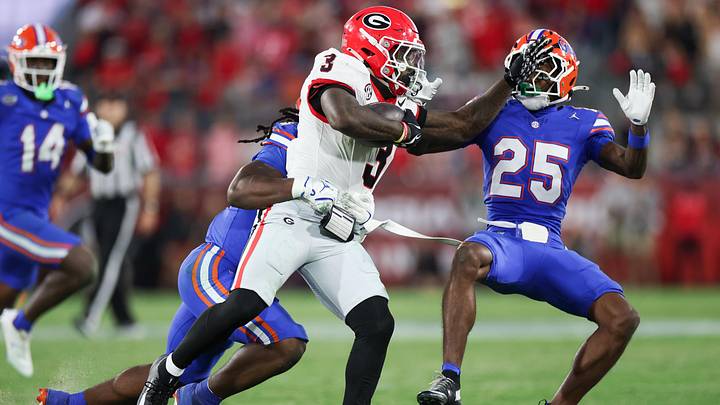 Nov 1, 2025; Jacksonville, Florida, USA; Georgia Bulldogs running back Nate Frazier (3) runs with the ball while stiff arming Florida Gators defensive back Cormani McClain (25) in the second half at EverBank Stadium. Mandatory Credit: Matt Pendleton-Imagn Images