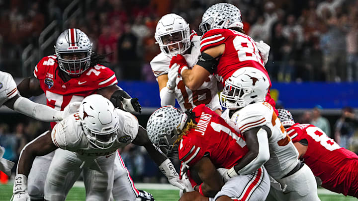 Ohio State running back Quinshon Judkins (1) is tackled by Texas Longhorns linebacker David Gbenda (33) during the College Football Playoff semifinal game in the Cotton Bowl at AT&T Stadium on Friday, Jan. 10, 2024 in Arlington, Texas.