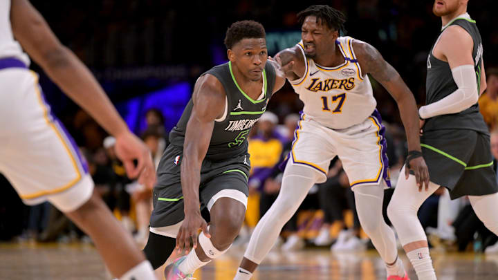 Apr 19, 2025; Los Angeles, California, USA; Minnesota Timberwolves guard Anthony Edwards (5) drives past Los Angeles Lakers forward Dorian Finney-Smith (17) in the second half at Crypto.com Arena. Mandatory Credit: Jayne Kamin-Oncea-Imagn Images