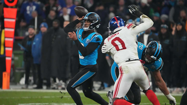 Nov 10, 2024; Munich, Germany; Carolina Panthers quarterback Bryce Young (9) throws the ball under pressure from New York Giants linebacker Brian Burns (0) in the second half during the 2024 NFL Munich Game at Allianz Arena. Mandatory Credit: Kirby Lee-Imagn Images Nov 10, 2024; Munich, Germany; Carolina Panthers quarterback Bryce Young (9) throws the ball under pressure from New York Giants linebacker Brian Burns (0) in the second half during the 2024 NFL Munich Game at Allianz Arena. Mandatory Credit: Kirby Lee-Imagn Images