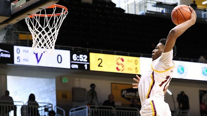 SEED School's Khaled Al-Mateen is airborne for an eventual dunk during the first quarter of Wednesday's Maryland Class 1A state boys basketball title game at UMBC. It was the first of his game-high 24 points for the Sabers, who won their first title with a 66-56 decision over Cambridge-South Dorchester.