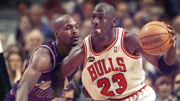 June 12, 1998; Chicago, IL, USA; Chicago Bulls guard Michael Jordan (23), right, goes up against Utah Jazz player Bryon Russell (3) in Game 5 of the 1998 NBA Finals.  