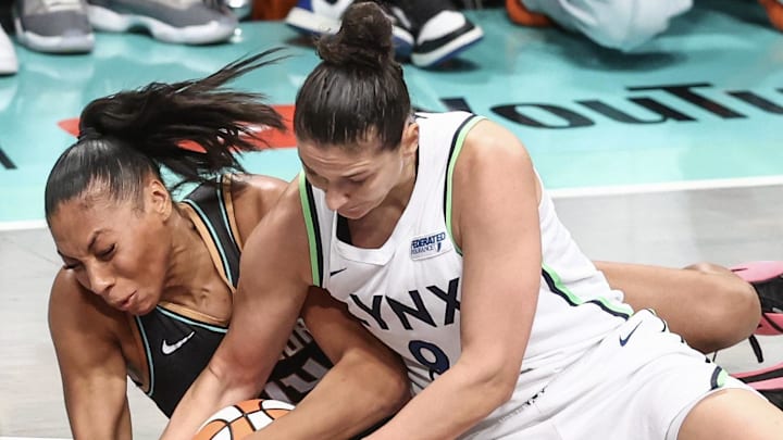 Oct 13, 2024; Brooklyn, New York, USA; New York Liberty forward Betnijah Laney-Hamilton (44) and Minnesota Lynx forward Cecilia Zandalasini (9) fight for a loose ball in the second quarter during game two of the 2024 WNBA Finals at Barclays Center. Mandatory Credit: Wendell Cruz-Imagn Images