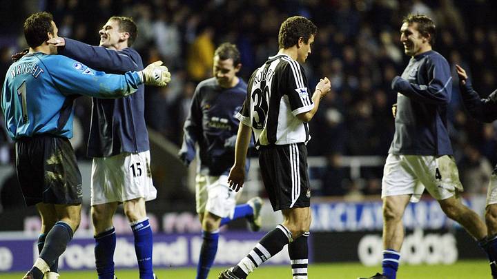 Laurent Robert of Newcastle is dejected after missing thehe jubilant Australian team lift the trohy