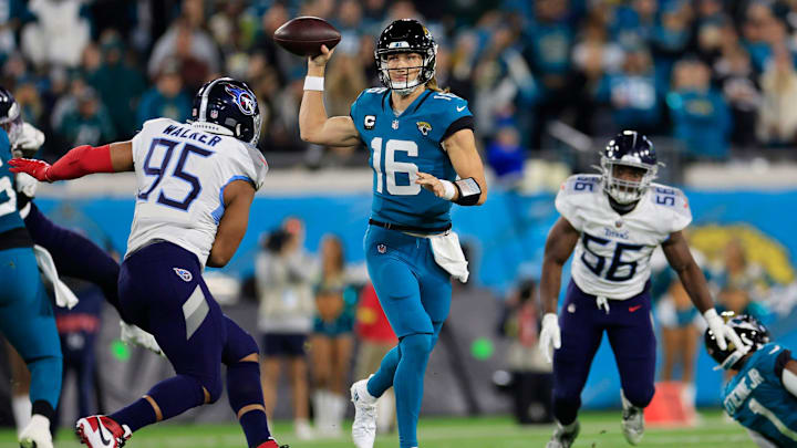 Jacksonville Jaguars quarterback Trevor Lawrence looks to pass against Tennessee Titans defensive end DeMarcus Walker during the second quarter of an NFL football regular season matchup, AFC South division title game, Saturday, Jan. 7, 2023.