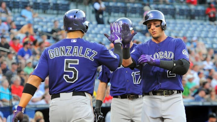 Jul 29, 2013; Atlanta, GA, USA; Colorado Rockies left fielder Carlos Gonzalez (5) and shortstop Troy Tulowitzki (2) react after scoring against the Atlanta Braves during the third inning at Turner Field. Jul 29, 2013; Atlanta, GA, USA; Colorado Rockies left fielder Carlos Gonzalez (5) and shortstop Troy Tulowitzki (2) react after scoring against the Atlanta Braves during the third inning at Turner Field.