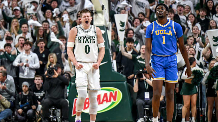 Michigan State's Jaxon Kohler, left, celebrates after making a 3-pointer against UCLA as the Bruins Xavier Booker, right, looks on during the first half on Tuesday, Feb. 17, 2026, at the Breslin Center in East Lansing.
