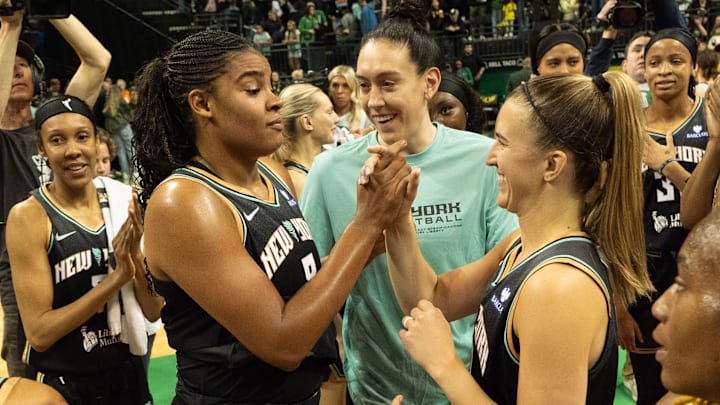 New York Liberty’s Nyara Sabally, left, and Sabrina Ionescu celebrate with teammates after the victory over the Toyota Antelopes.