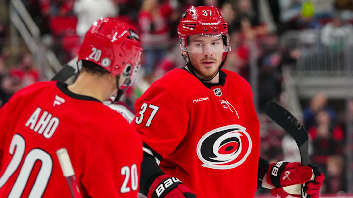 Dec 5, 2024; Raleigh, North Carolina, USA;  Carolina Hurricanes right wing Andrei Svechnikov (37) celebrates his empty net goal with center Sebastian Aho (20) against the Colorado Avalanche during the third period at Lenovo Center. Mandatory Credit: James Guillory-Imagn Images