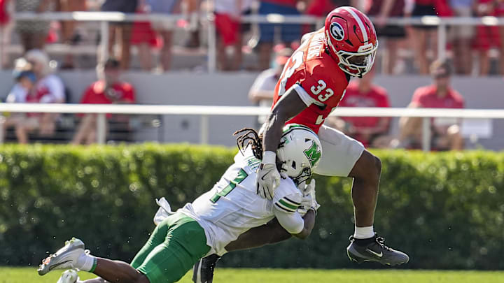 Aug 30, 2025; Athens, Georgia, USA; Georgia Bulldogs running back Chauncey Bowens (33) runs against Marshall Thundering Herd defensive back Boogie Trotter (1) at Sanford Stadium. Mandatory Credit: Dale Zanine-Imagn Images Aug 30, 2025; Athens, Georgia, USA; Georgia Bulldogs running back Chauncey Bowens (33) runs against Marshall Thundering Herd defensive back Boogie Trotter (1) at Sanford Stadium. Mandatory Credit: Dale Zanine-Imagn Images