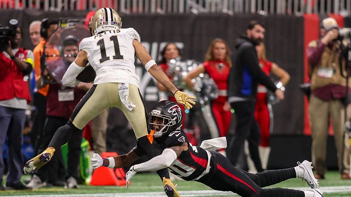 Jan 4, 2026; Atlanta, Georgia, USA; Atlanta Falcons cornerback Dee Alford (20) tackles New Orleans Saints wide receiver Dante Pettis (11) in the first quarter at Mercedes-Benz Stadium. Jan 4, 2026; Atlanta, Georgia, USA; Atlanta Falcons cornerback Dee Alford (20) tackles New Orleans Saints wide receiver Dante Pettis (11) in the first quarter at Mercedes-Benz Stadium.