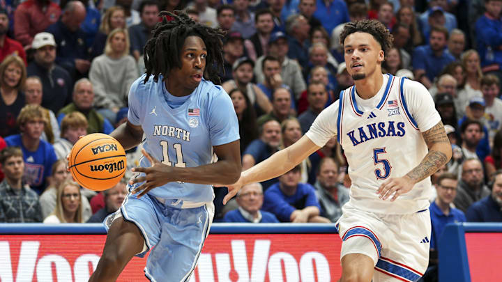 Nov 8, 2024; Lawrence, Kansas, USA; North Carolina Tar Heels guard Ian Jackson (11) drives against Kansas Jayhawks guard Zeke Mayo (5) during the first half at Allen Fieldhouse. Mandatory Credit: Jay Biggerstaff-Imagn Images